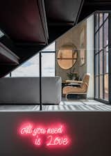 Living Room, Accent Lighting, Sectional, Dark Hardwood Floor, Corner Fireplace, and Ottomans  Photo 10 of 10 in Virrey Apartment by Nicolas Mujica