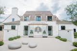 Home exterior features white stucco, cedar wood trim, custom black window frames and handmade front door from Poland.