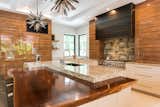 Kitchen, Marble Counter, Wood Counter, Range, Cooktops, Range Hood, Ceiling Lighting, Pendant Lighting, and Refrigerator Main Kitchen   Photo 14 of 19 in Mid Century Modern by Tongue & Groove Design + Build