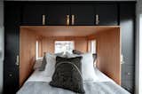 Gooseneck Tiny home with large bedroom with storage headboard and hydraulic assist storage bed, by Tru Form Tiny