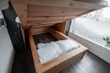 Gooseneck Tiny home with large bedroom with storage headboard and hydraulic assist storage bed, by Tru Form Tiny