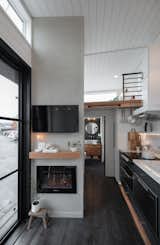 Gooseneck Tiny home with lime wash mantel wall and TV, by Tru Form Tiny
