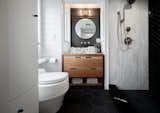 Gooseneck Tiny home with black and white tile bathroom, marble bathroom sink, and Parisian accents., by Tru Form Tiny