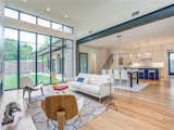 white oak flooring, continuous steel beam support element, white and blue lacquer cabinets. 