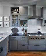 Kitchen, Granite Counter, Cooktops, Recessed Lighting, Colorful Cabinet, Marble Counter, Subway Tile Backsplashe, and Light Hardwood Floor Shaker style cabinets, subway tile, calcutta  absolute honed black stone  counters  Photo 7 of 10 in What, a dark blue farmhouse? by William Corker