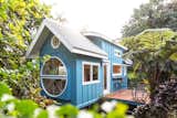 Oasis Tiny House, clad in teal-painted plywood and a metal roof that's pitched in the front and curved in the rear, was designed and built by Ellie and Dan Madsen of Paradise Tiny Homes in Keaau, Hawaii.