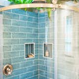 A skylight and live plants in the bathroom shower supply the feeling of bathing outdoors. 