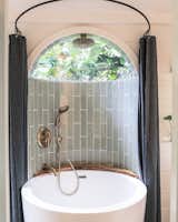 One surefire way to make your tiny bathroom feel more significant is to expand or modify the home’s footprint—even just a little bit. Paradise Tiny Homes designed this tiny house with a curved outset in the bathroom, making it the perfect space to add a small, round bathtub. Adding a domed skylight makes this compact bathroom feel larger and more lavish.
