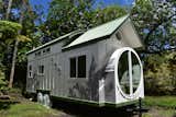 The Oasis model tiny home in white and green- Paradise Tiny Homes