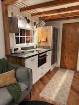 This range is propane and was made for an RV. Its glass top makes for a sleek clean look.
A galley kitchen with quartz countertops any appliances you want, and custom cabinetry with everything built-in. copper pipes run through the exposed ceiling beams for mass amounts of kitchen storage. Hanging things is the best form of storage for any kitchen in my humble opinion.