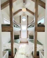 A tiny home with 2 sets of bunk beds (4 twin beds), 5 beds total, can sleep 8 with the couch. 6 people living in this tiny home.