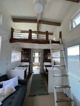 2 sets of bunkbeds, a galley kitchen, a closet, a sleeping loft, and a ladder. 
Built By: Paradise Tiny Homes
Designed By: Ellie K Design