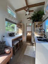 The tiny home galley kitchen in white, wood and black