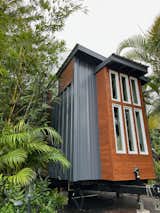 Exterior, Small Home Building Type, Glass Siding Material, Metal Roof Material, Beach House Building Type, Shed RoofLine, Tiny Home Building Type, Metal Siding Material, Flat RoofLine, ADU Building Type, and Wood Siding Material cedar wood and metal tucked into the lush jungle  Photo 16 of 21 in The 2nd Ohana Model ATU- Built By: paradisetinyhomes.com by elliekdesign.com