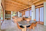 The kitchen blends wood, stone, and marine-grade steel. Natural light and breezes filter in through the sliding doors, while shoji-inspired partitions nod to Japanese design.