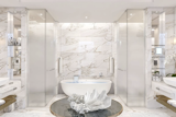 Swaths of marble make the bathroom feel like a personal spa.