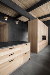 Kitchen, Granite Counter, Pendant Lighting, Refrigerator, Wall Oven, Wood Cabinet, and Slate Floor Freestanding Kitchen Cabinets with integrated appliances  Photo 3 of 16 in The Serenity House by Olivier Blouin
