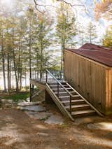 Stairs run up the south side of the cabin to the new deck, which sits atop the dining addition and is accessible from the primary suite. “The couple can go from the lake right up to their bathroom,” Sutherland says.
