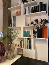 Antonio designed thin shelves with hinged storage boxes that do double duty as structural elements. "It's a play between solid and void," he says about the open and closed design.