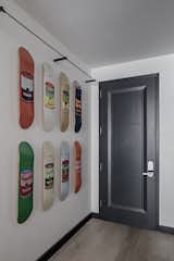 In the entry of Marc and Dustin’s home, limited-edition skate decks with Andy Warhol's Campbell's Soup cans are a prelude of what's to come in the SoHo loft. Designer Kyle O'Donnell, who will open a by-appointment storefront studio in the West Village this coming spring, swapped the builder-grade door with a door boasting an angled inset design. 