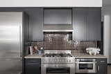 O'Donnell spruced up the kitchen with new cabinet fronts painted black and a glossy, chocolate brown backsplash.