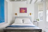 The owner's 23-year old daughter sleeps ere when she visits from the West Coast. The flower painting above the bed is her childhood artwork and the blue painting is by New York City artist John Zinsser.