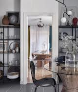 Freestanding shelves in the kitchen hold dishes, glasses, and local ceramics. "This region is very rich in small decorative forms,