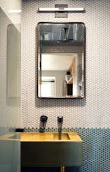 Penny tiles create visual interest and add texture to an otherwise quiet bathroom.&nbsp;