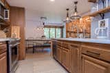 Chef's kitchen with Kitchen Aid appliances, wood cabinets, quart countertops