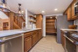 Chef's kitchen with Kitchen Aid appliances, wood cabinets, quart countertops
