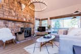 Living Room, Sectional, Coffee Tables, Wood Burning Fireplace, Ceiling Lighting, Vinyl Floor, Accent Lighting, and Wall Lighting Custom rock fireplace, West Elm furnishings, views of the mountain  Photo 5 of 21 in Cabin at Mammoth Mountain by sophia lin