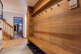 Foyer with oak wood paneling, lots of hooks for winter coats and ski gear
