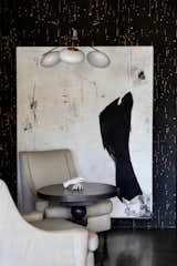 A spare hidden murphy bed in the loft's breakfast nook is disguised by a custom large scale abstract art piece.