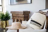 A one of a kind fabric pillow and an inlay game table from Morocco add texture next to this Barbara Barry reading chair.