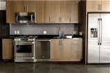 Hand stained cabinets and black penny tile are warm and classic in this kitchen.