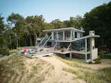 Exterior, House Building Type, Shed RoofLine, Concrete Siding Material, Wood Siding Material, Stone Siding Material, Metal Roof Material, and Green Roof Material Beach side  Photo 13 of 16 in Bridgehouse by Robert Neylan