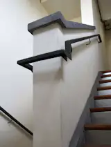Inspired by an old planing mill handrail this bent plate wraps its way around plaster walls while the galvanized risers brighten up the fire stair