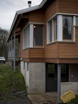 Looking across the front of the house with basement entrance at grade