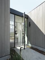 Grey tones of the exterior yield to the white walls of the spa-like interior.