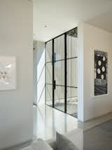 Glass and steel doors usher in the light.