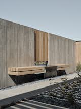 A custom fountain is embedded into the board-formed concrete wall.