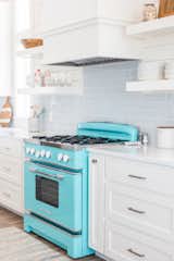 The open-style kitchen includes a Big Chill 36” Retro Stove in Beach Blue requested by the home’s owners.