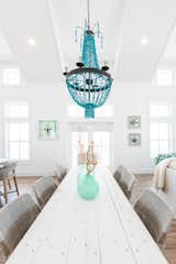  A stunning turquoise chandelier further enhances the statement-making vaulted ceilings and creates a central focal point between the three spaces.