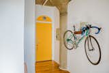 Hallway and Medium Hardwood Floor This prized, beautiful bike deserves its own wall display!  Photo 11 of 11 in Modern-Maximalist City Loft by Indigo Ink Designs