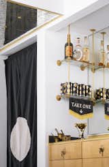 I designed this brass bar shelving to look like it was original to the house. The wet bar is also fully custom down to the brass tassel pulls.