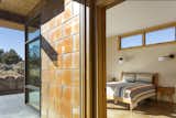 Bedroom, Wall Lighting, Night Stands, Bed, and Concrete Floor Escalante Escape exterior / bedroom featuring the corten steel panel cladding and concrete floors  Photo 5 of 9 in Escalante Escape by Coates Design Seattle Architects