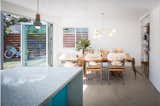 The pantry, laundry, and half bath to the right are concealed by a large barn door.