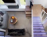 The juxtaposition of the ultra-contemporary acrylic stairs ending in a rammed earth landing and final steps reflects the owner's eclectic aesthetic.