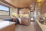Wooden ceilings and cabinets give the kitchen an authentically retro feel