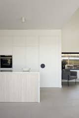 Kitchen, Stone Slab Backsplashe, Wall Oven, Ceramic Tile Floor, White Cabinet, Ceiling Lighting, and Marble Counter  Photo 16 of 22 in Warraweena by Pitch Architecture + Design 